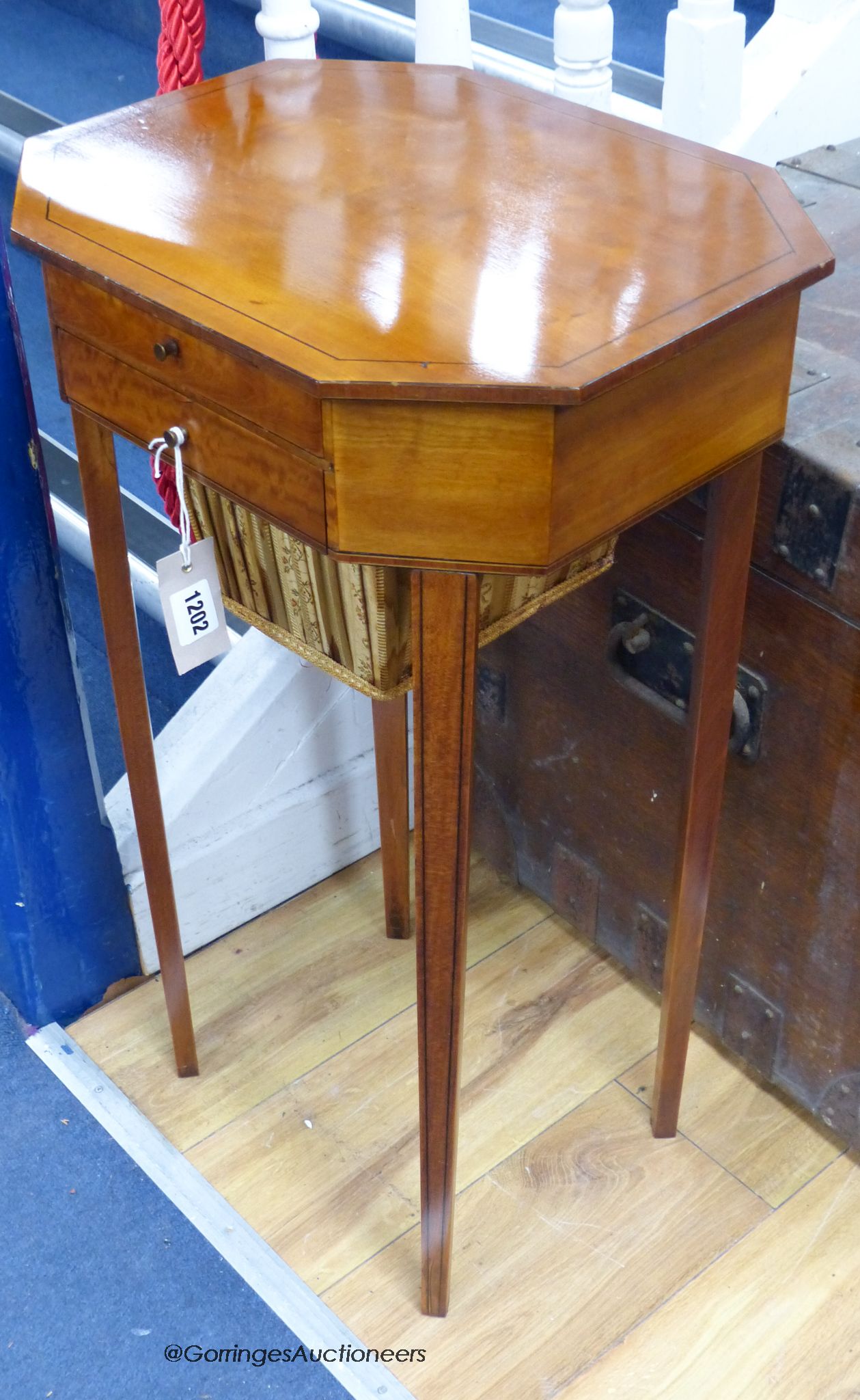 A Sheraton style octagonal satinwood sewing table. W-41, D-33, H-73cm.